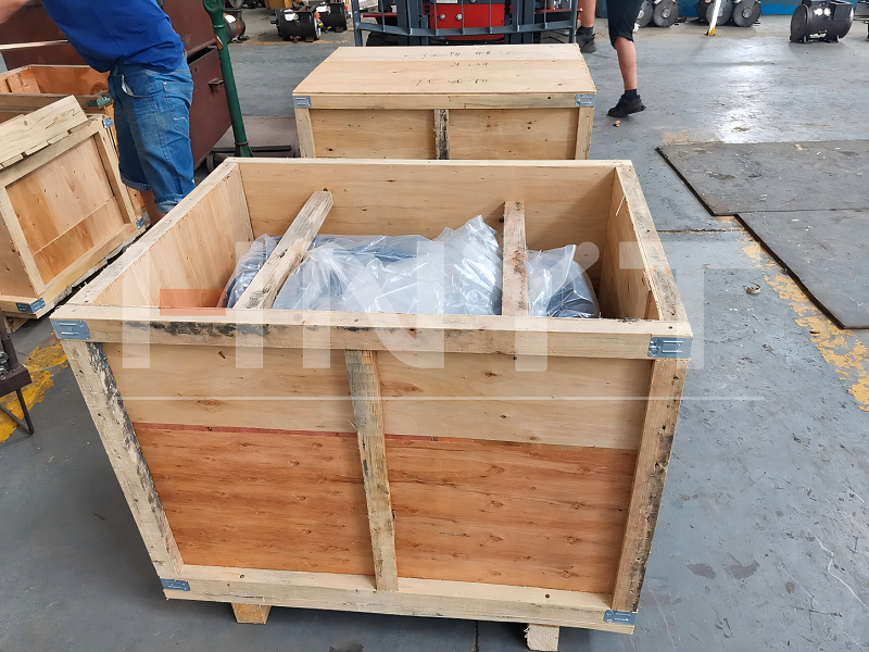 A motor covered with plastic inside a wooden case during packing.png